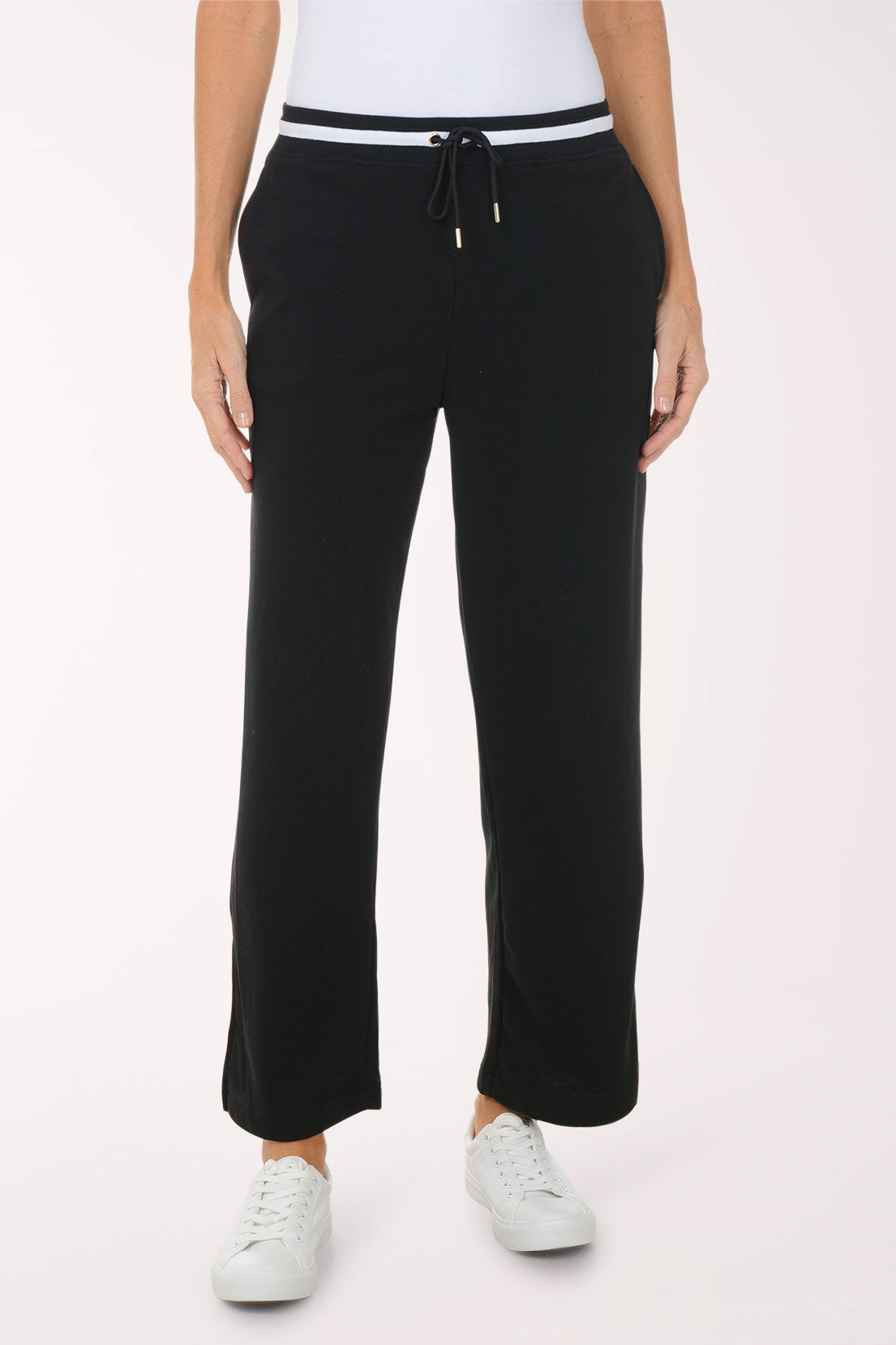 Woman wearing a black outfit with a heart emblem on a white background