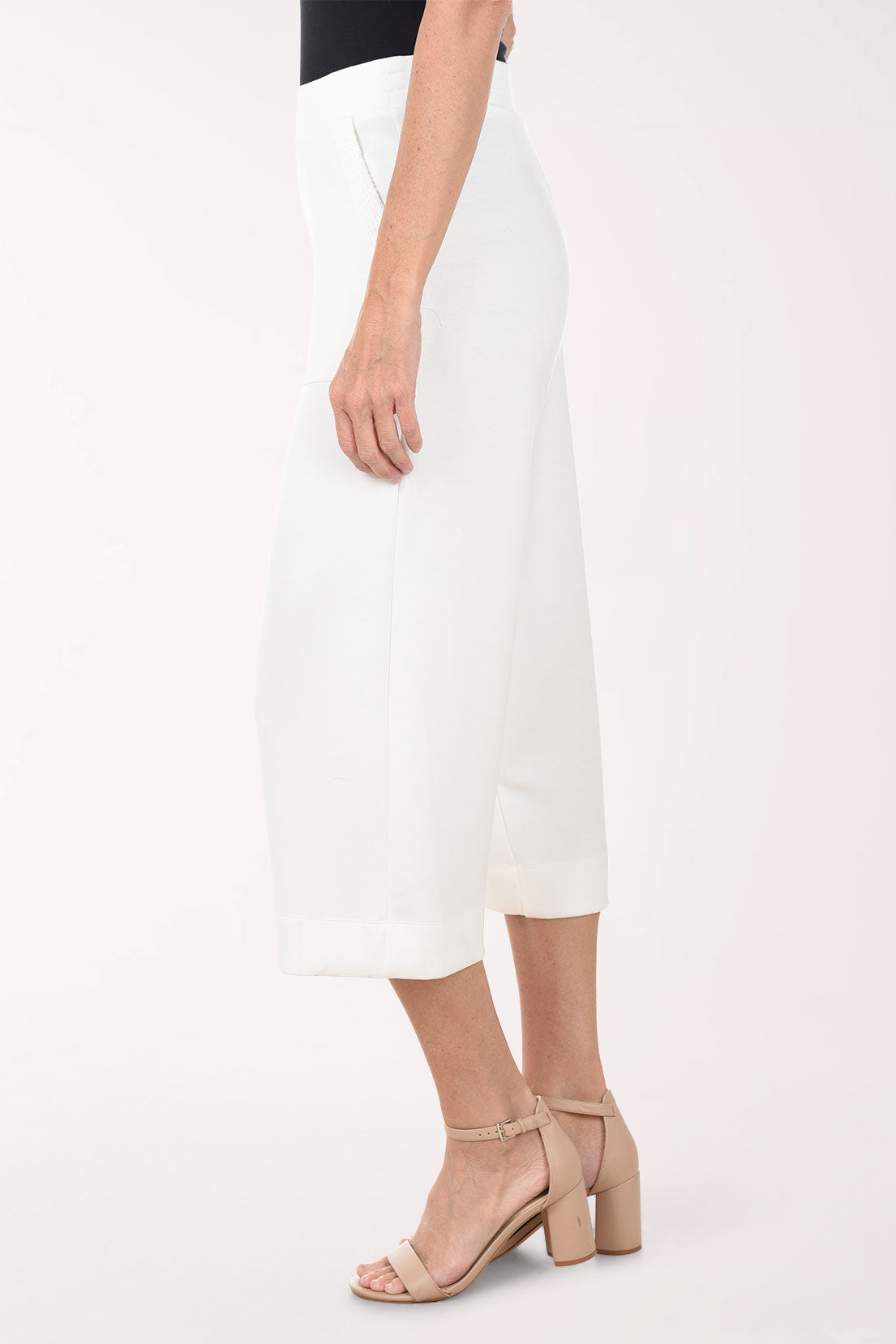 White wide-leg pants worn by a person on a white background