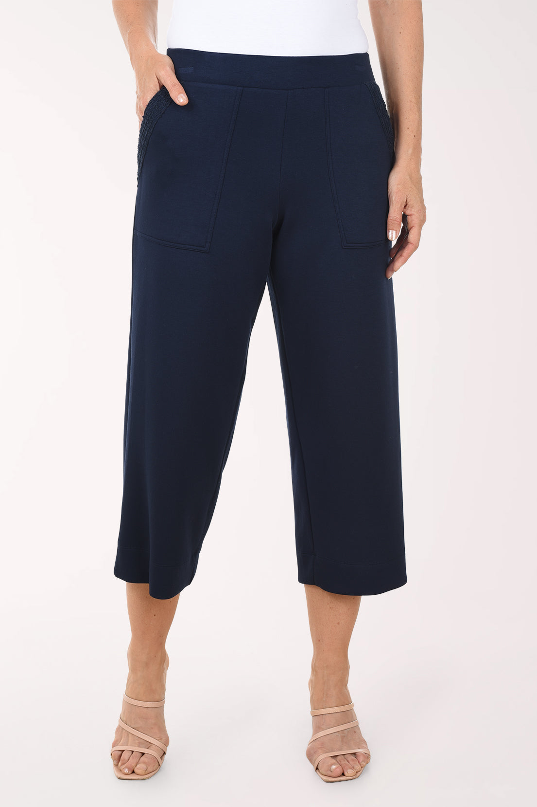 Navy blue wide-leg pants worn by a person on a white background