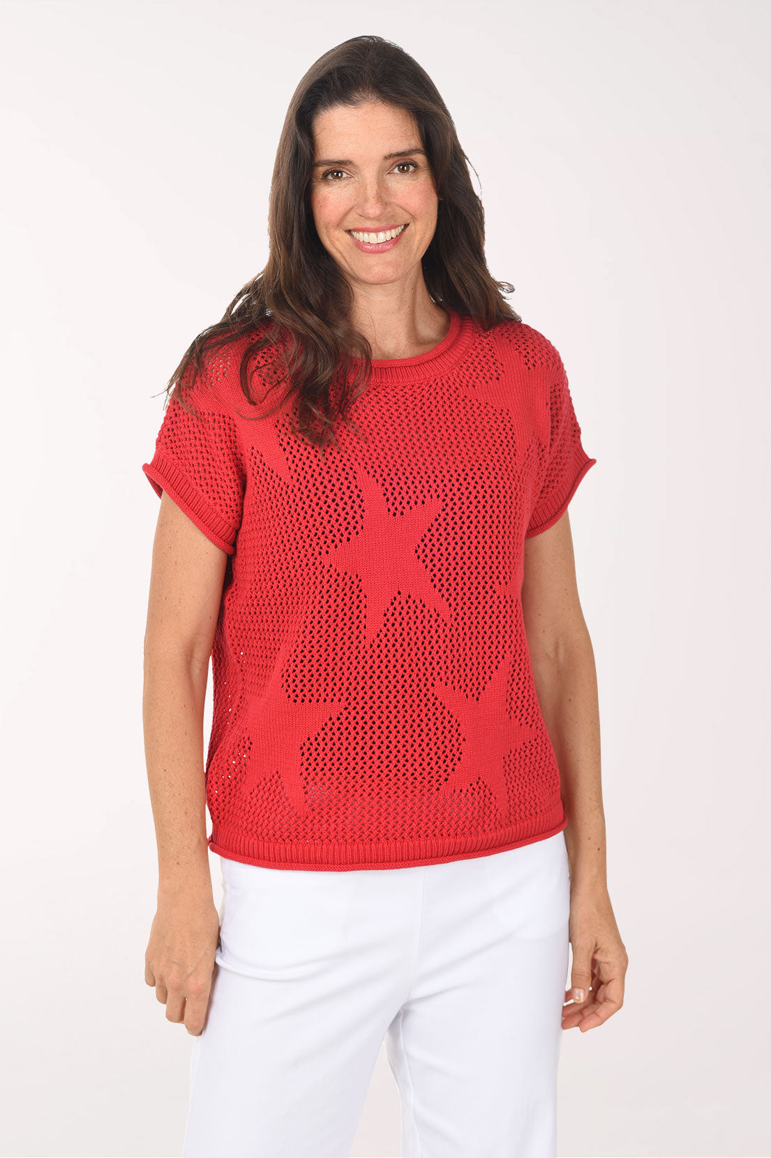 Woman wearing a red star-patterned sweater on a white background
