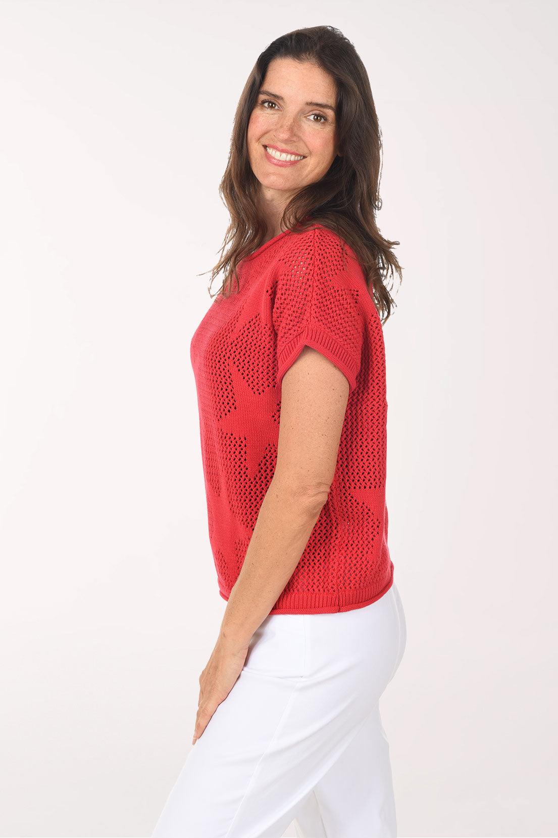 Woman wearing a red star-patterned sweater on a white background