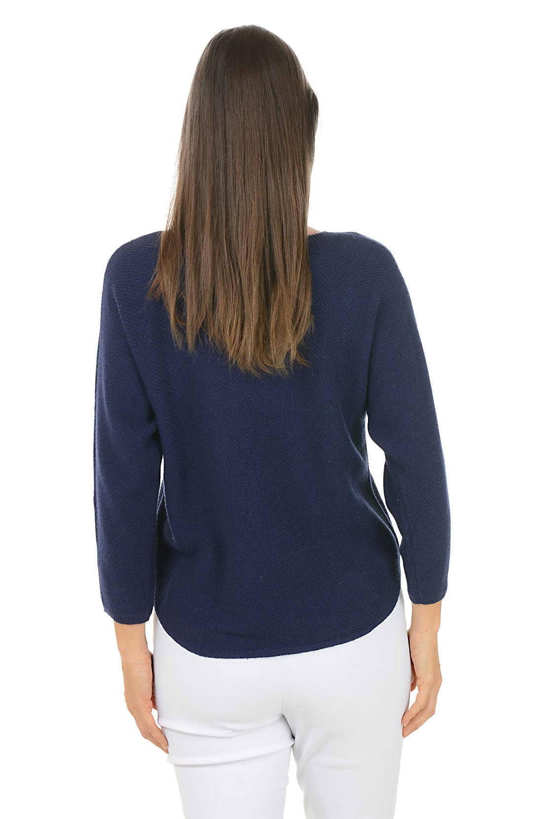 Woman wearing a navy sweater with a colorful heart design on a white background. Back shot.