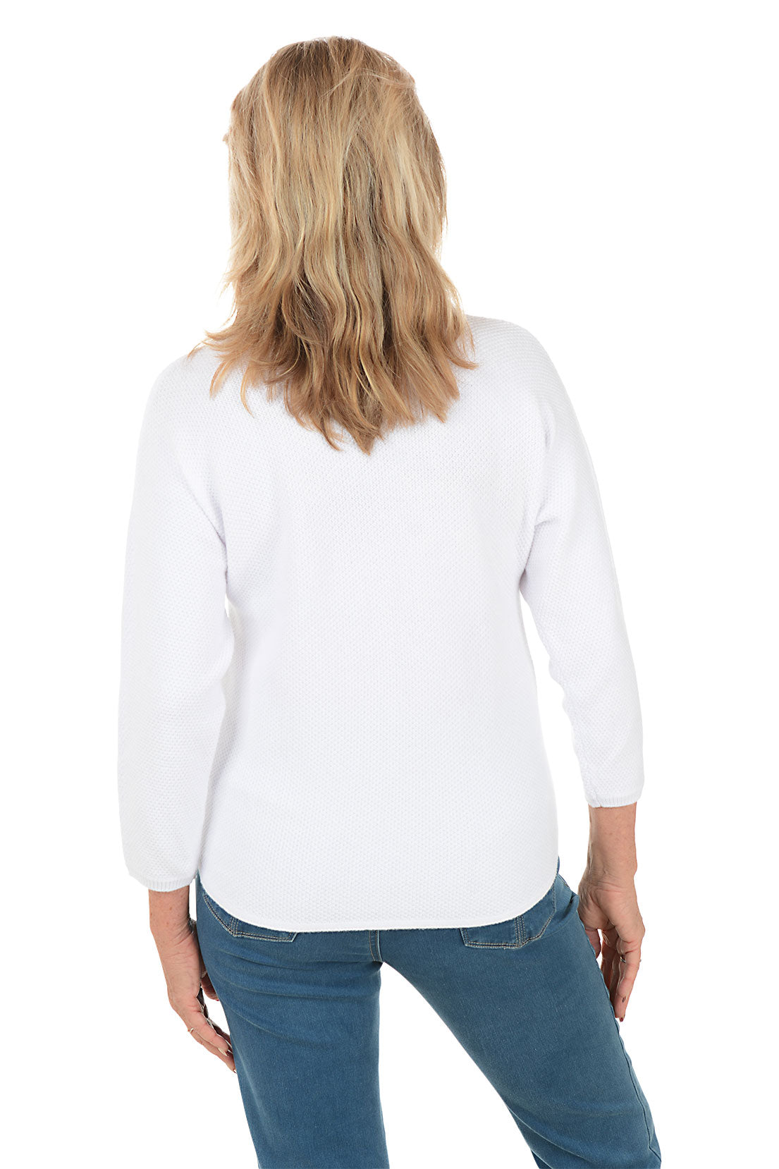 Woman wearing a white sweater with a colorful snowflake design on a white background. Back shot.