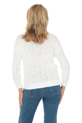 Woman wearing a white sweater with a blue shell design on a white background. Back shot.