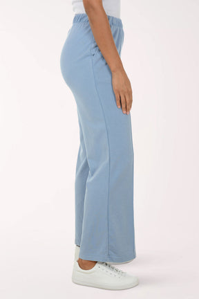 Light blue pants worn by a person on a white background