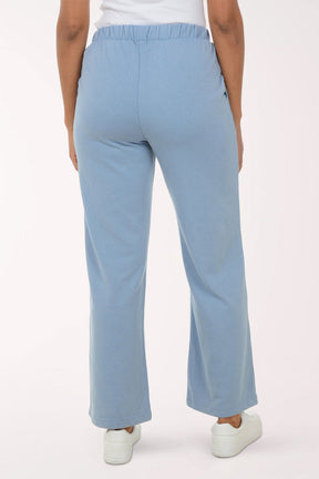 Light blue pants worn by a person on a white background