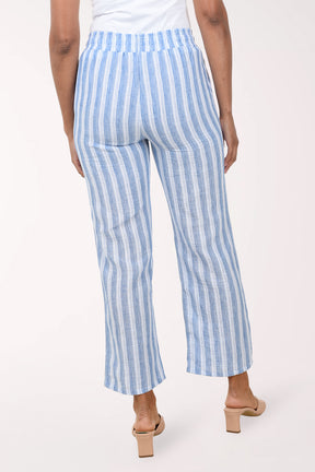 Blue and white striped pants worn by a person on a white background