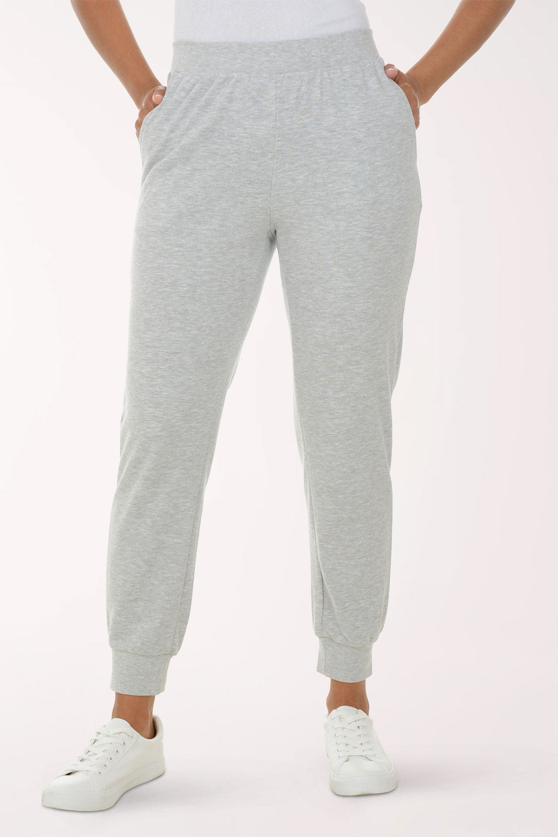 Person wearing gray sweatpants on a white background
