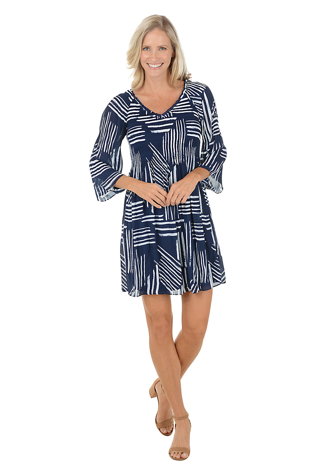 Woman wearing a navy blue and white "sketched lines" patterned dress with 3/4 bell sleeves.