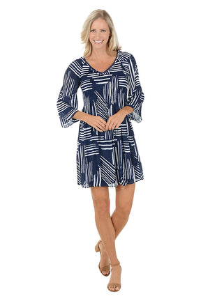 Woman wearing a navy blue and white "sketched lines" patterned dress with 3/4 bell sleeves.