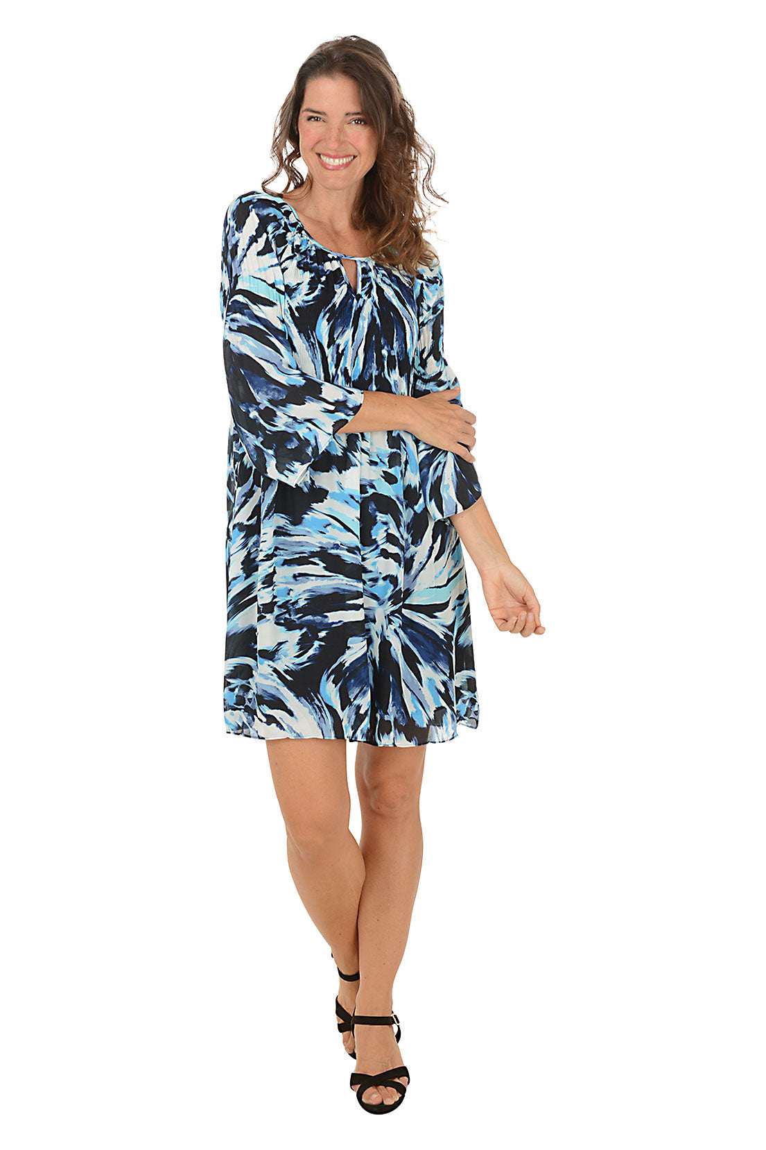 Woman wearing a blue and white patterned dress on a white background.