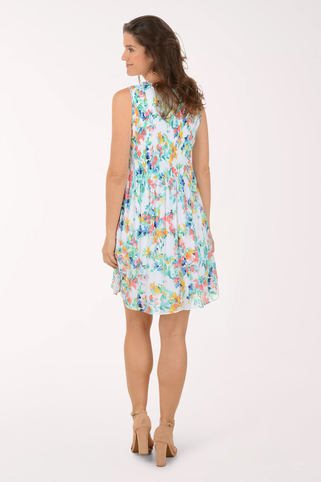 Woman wearing a colorful floral dress on a white background