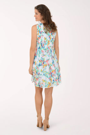 Woman wearing a colorful floral dress on a white background