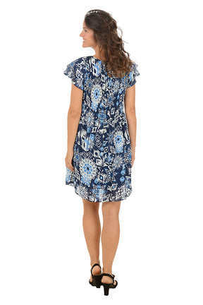 Woman wearing a ruffled short sleeve blue floral dress on a white background. Back shot.
