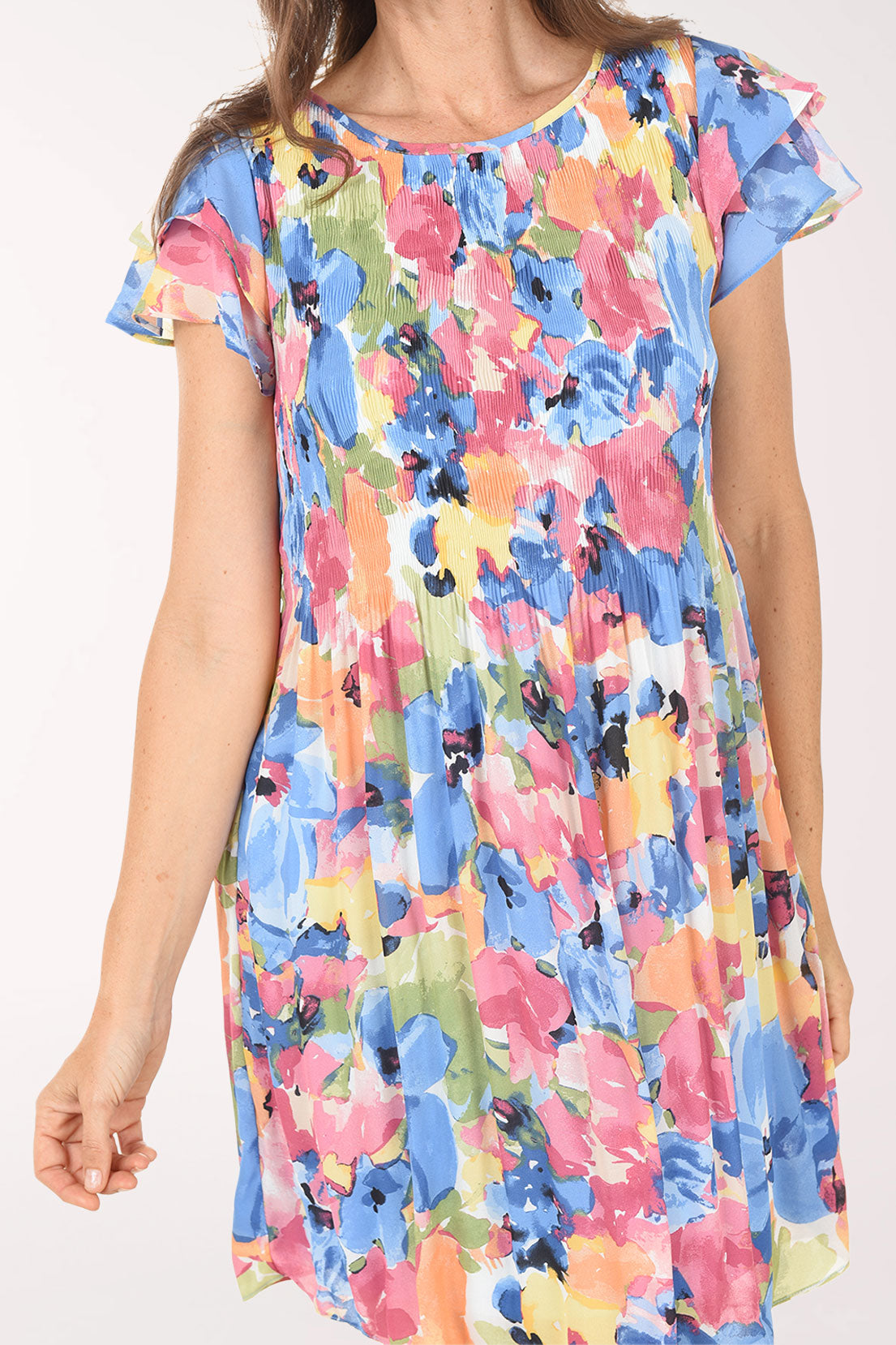 Woman wearing a colorful floral dress on a white background