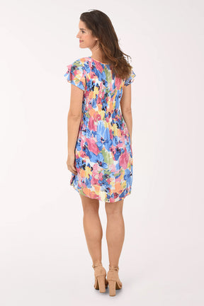Woman wearing a colorful floral dress on a white background