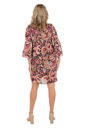 Woman wearing a red multi paisley patterned dress with 3/4 sleeves. Back shot.