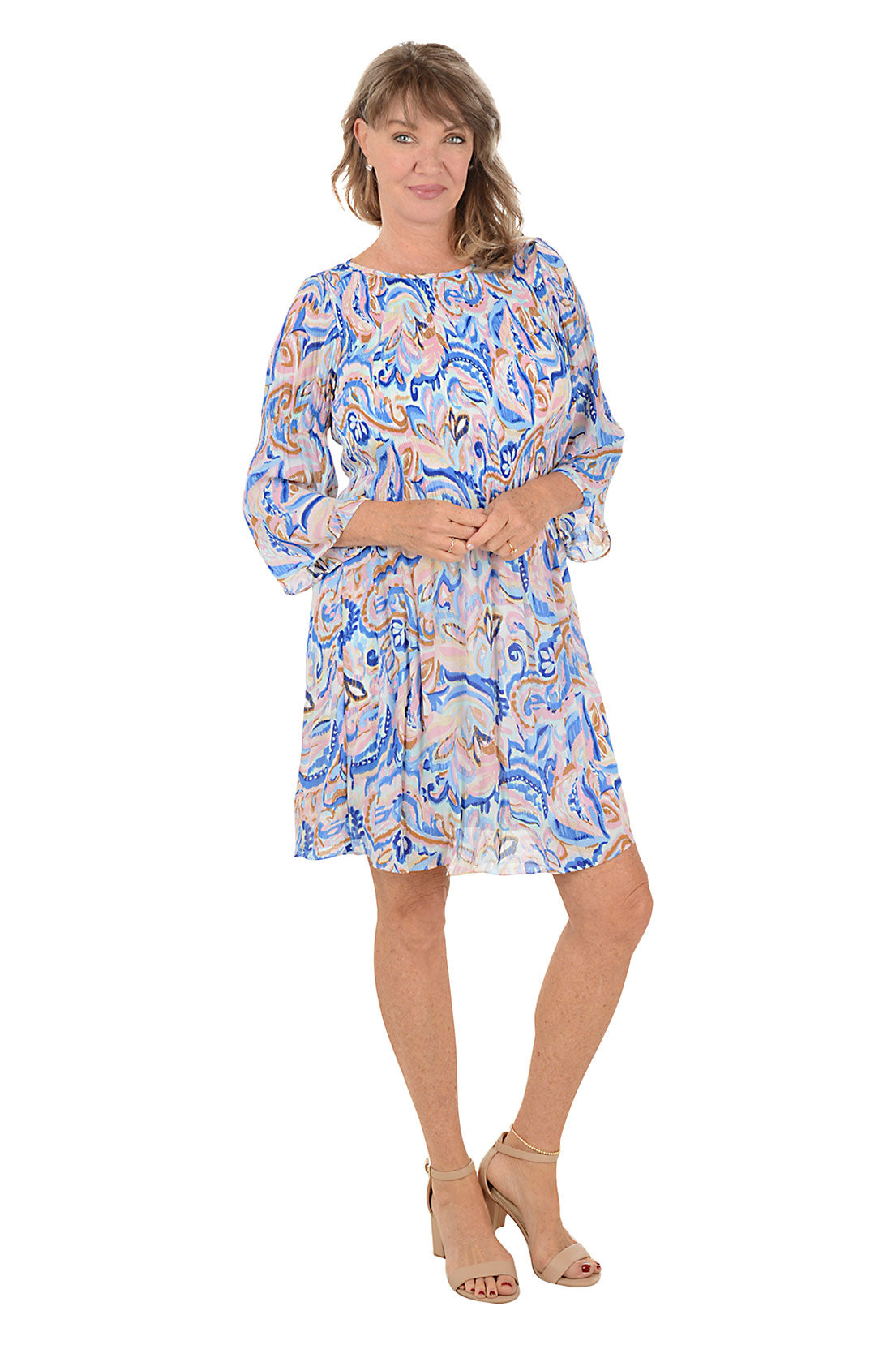 Woman wearing a blue multi paisley patterned dress with 3/4 sleeves.