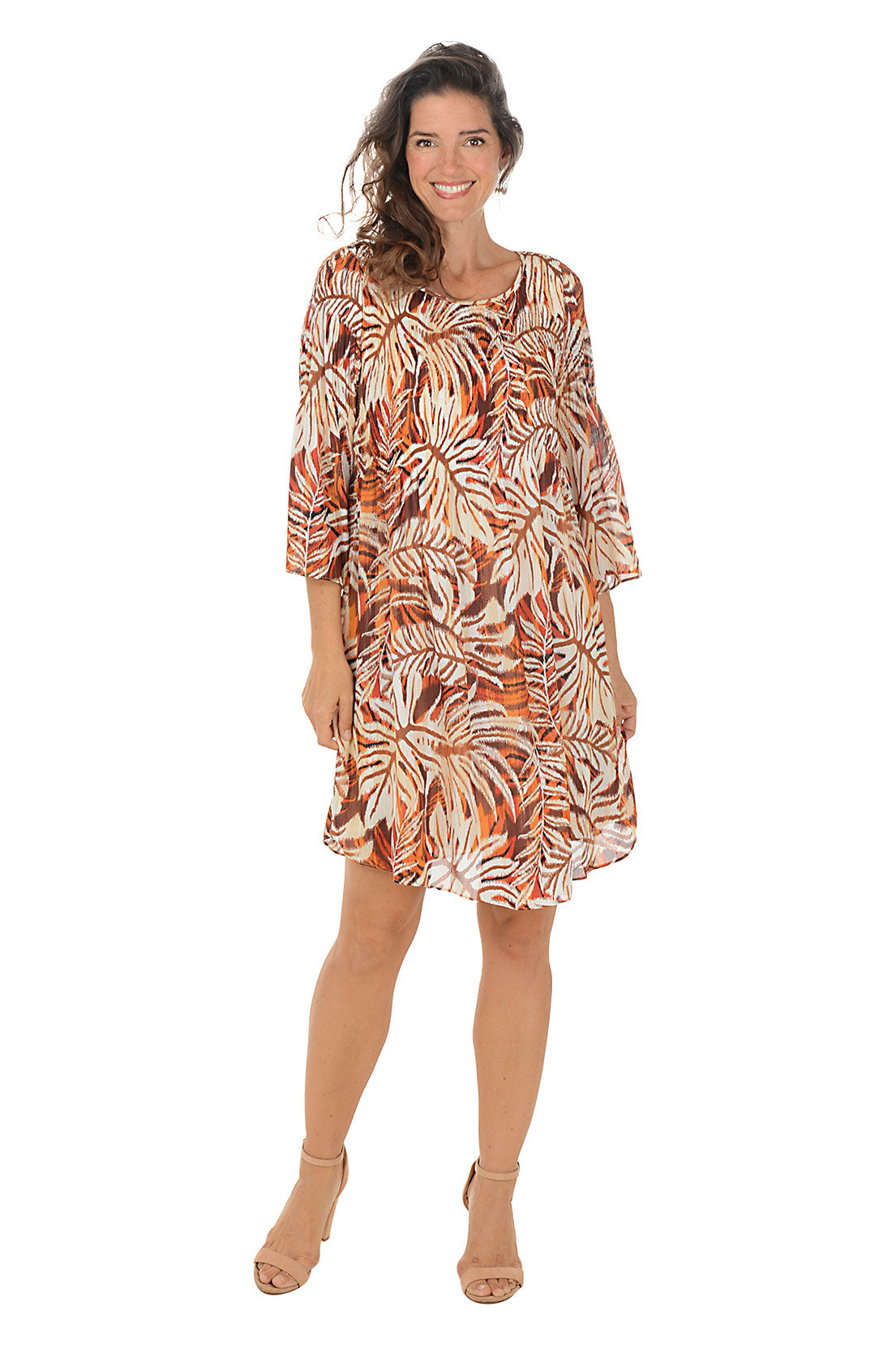 Woman wearing a patterned dress on a white background.