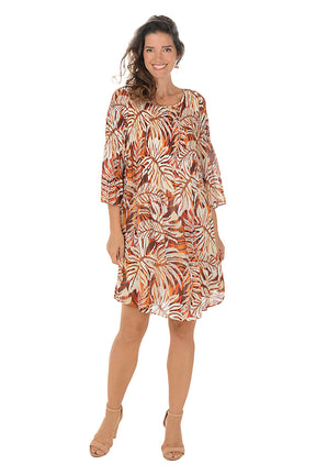 Woman wearing a patterned dress on a white background.