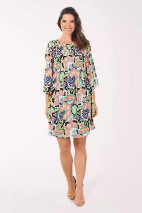 Woman wearing a colorful floral dress on a white background