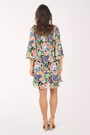 Woman wearing a colorful floral dress on a white background