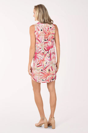 Woman wearing a sleeveless dress with a floral pattern on a white background