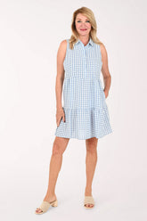 Woman wearing a sleeveless gingham blue dress