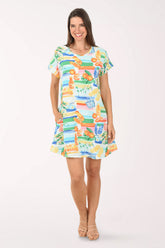 Woman wearing a colorful dress with a pattern on a white background
