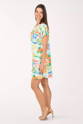 Woman wearing a colorful dress with a pattern on a white background