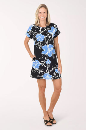 Woman wearing a black dress with blue floral patterns on a white background