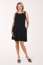 Woman wearing a sleeveless black dress 