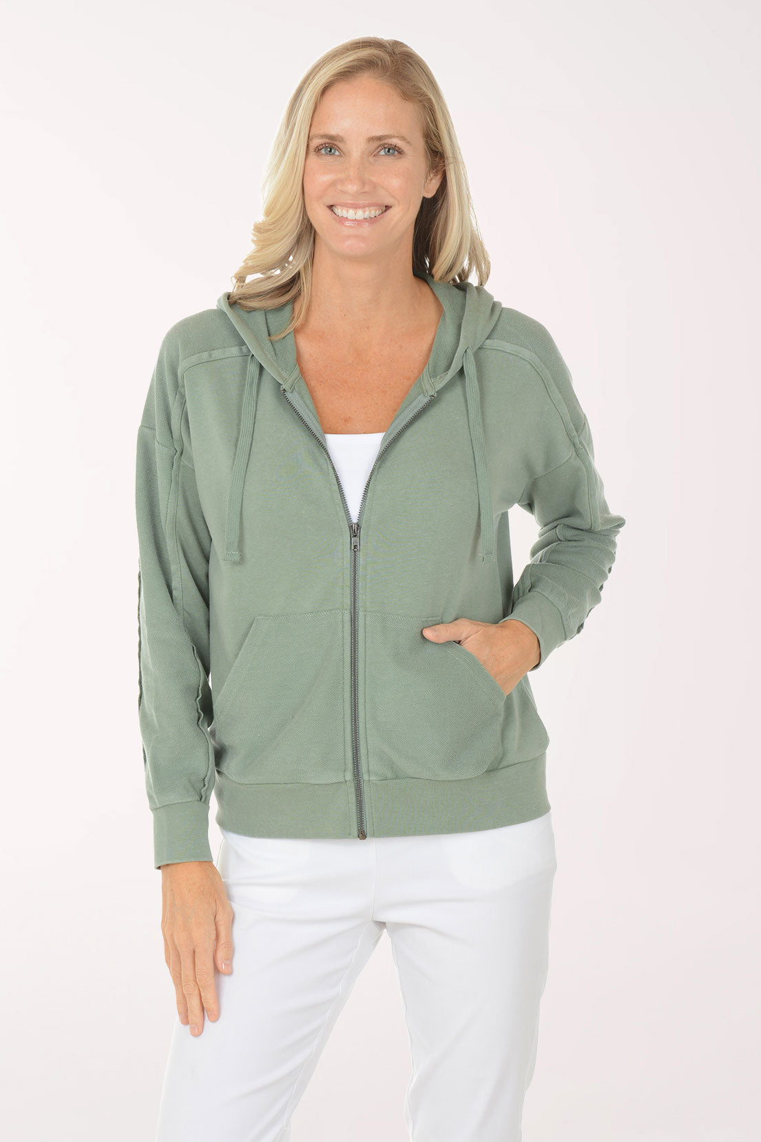 Woman wearing a green hoodie on a white background