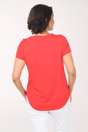 Woman wearing a red shirt on a white background