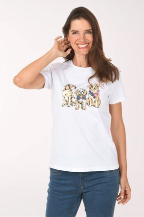 Woman wearing a white t-shirt with dog illustrations on a plain background