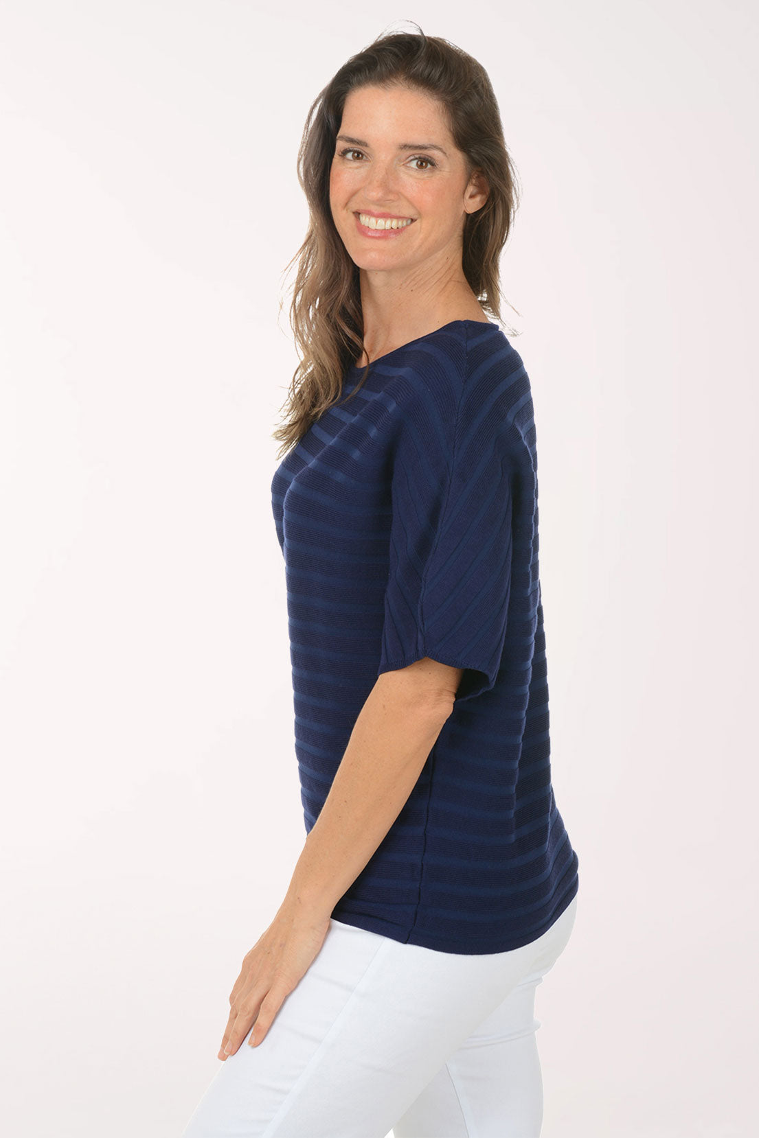 Woman wearing a short sleeve boxy navy top.