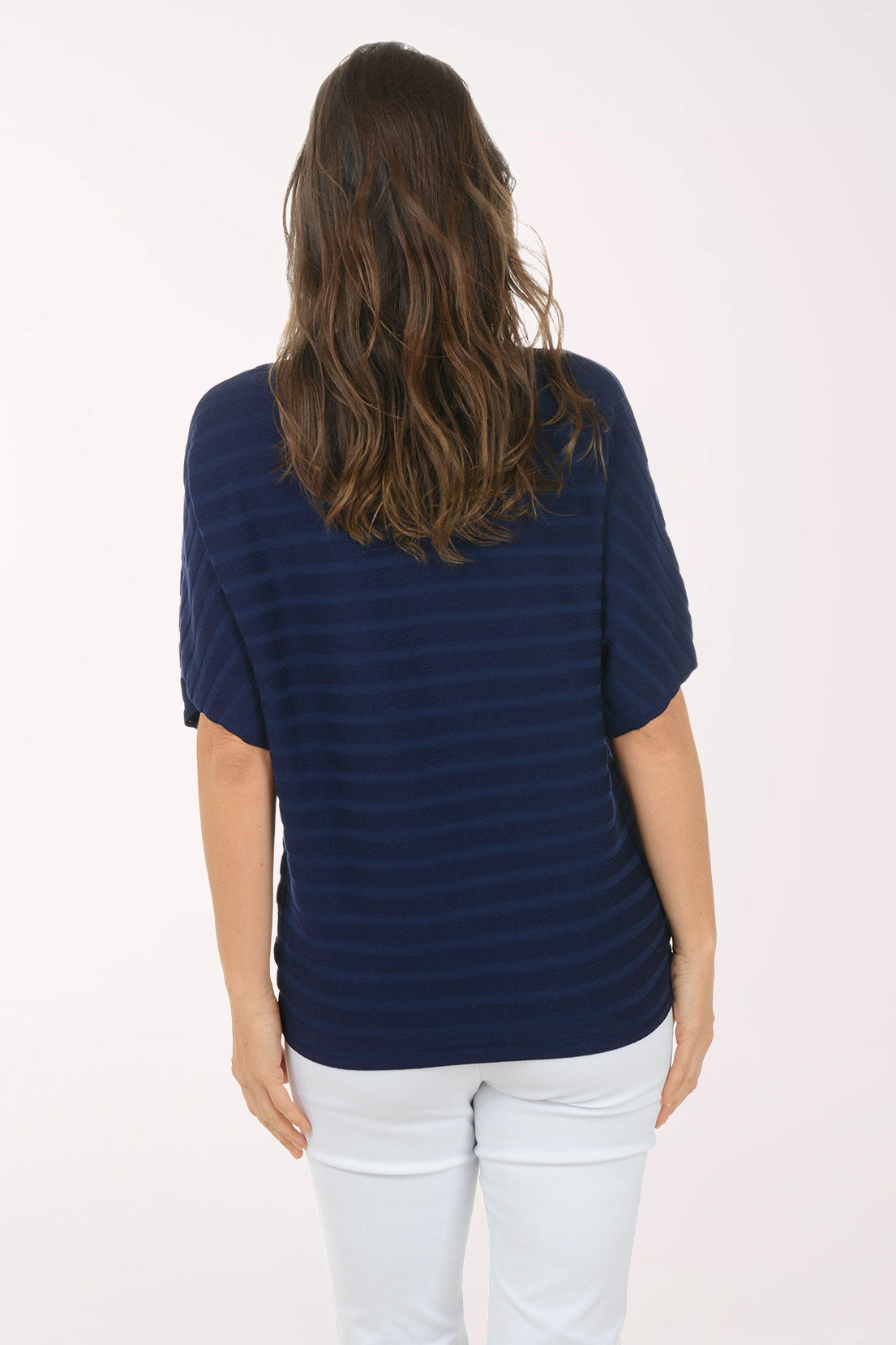 Woman wearing a short sleeve boxy navy top.