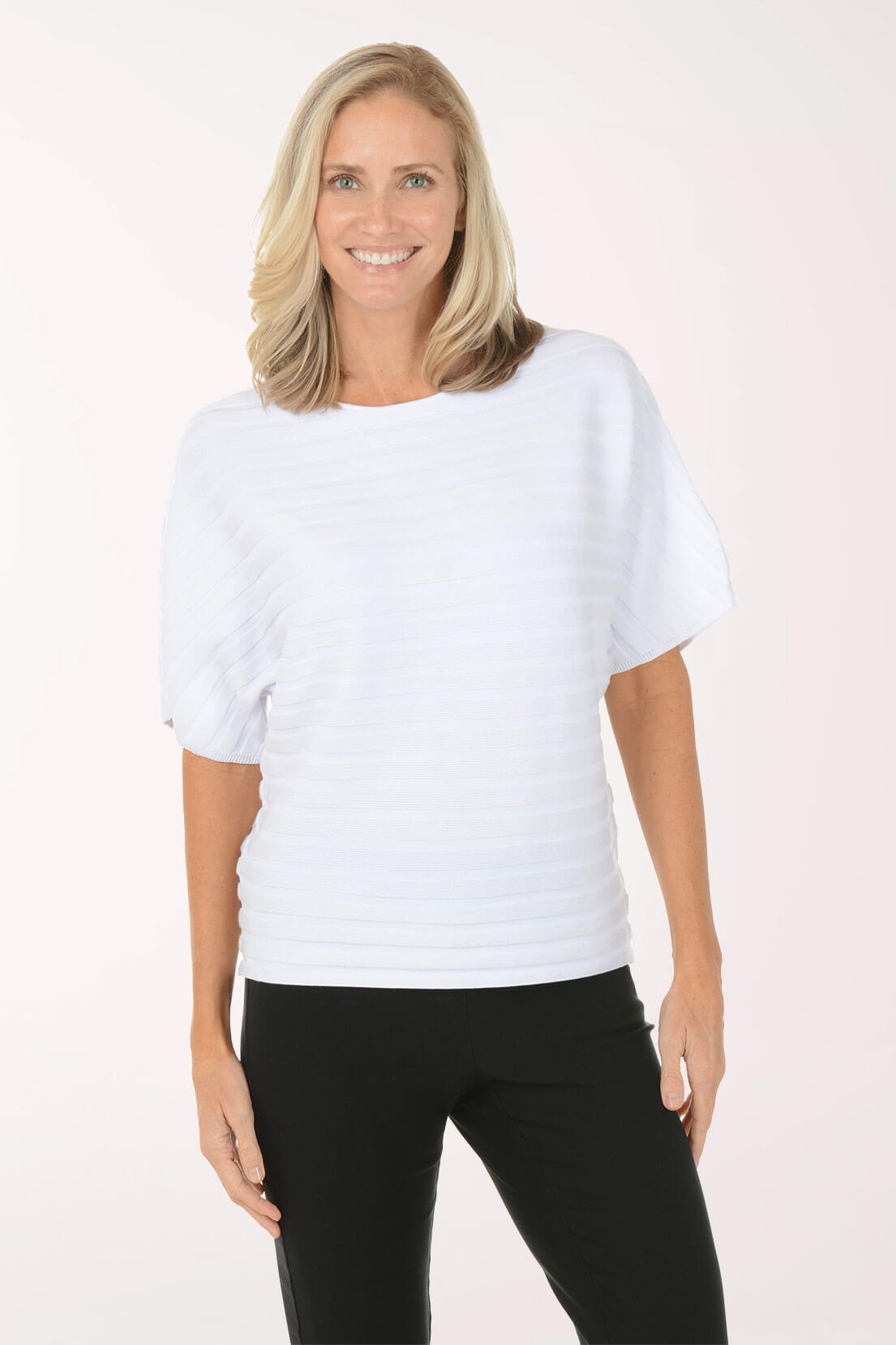 Woman wearing a white top and black pants on a white background