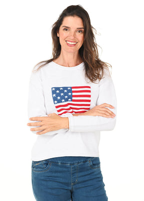 Woman wearing a white sweatshirt with an American flag design on a white background