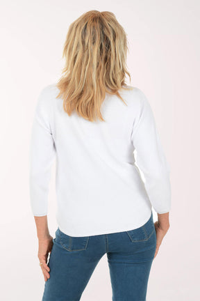 Woman wearing a white sweatshirt with a colorful daisy design on a white background. Back shot