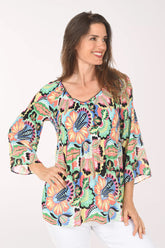 Woman wearing a colorful floral blouse on a white background