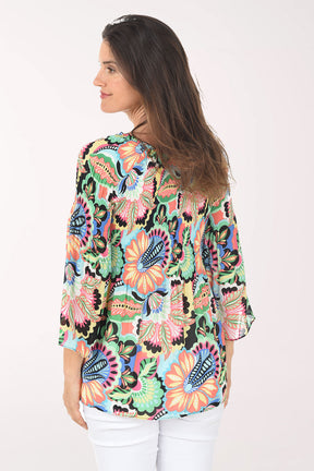 Woman wearing a colorful floral blouse on a white background