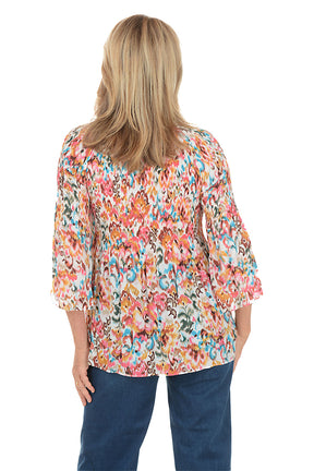 Woman wearing a colorful floral blouse and blue jeans on a white background. Back shot.