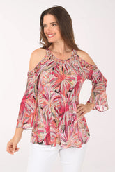 Woman wearing a colorful floral blouse on a white background