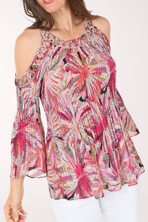 Woman wearing a colorful floral blouse on a white background