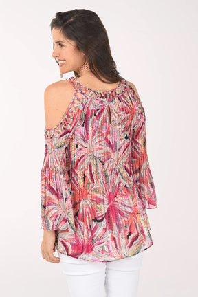 Woman wearing a colorful floral blouse on a white background