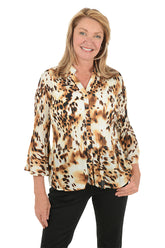Woman wearing a leopard print blouse on a white background.