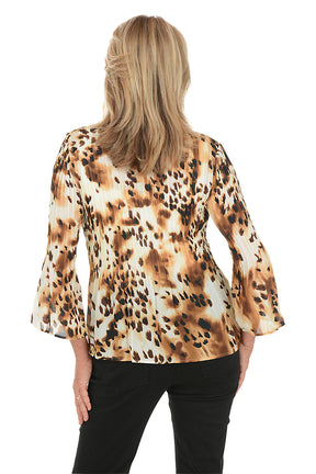 Woman wearing a leopard print blouse on a white background. Back shot.