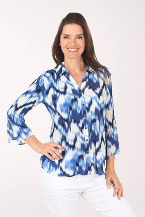 Woman wearing a blue and white tie-dye shirt on a white background