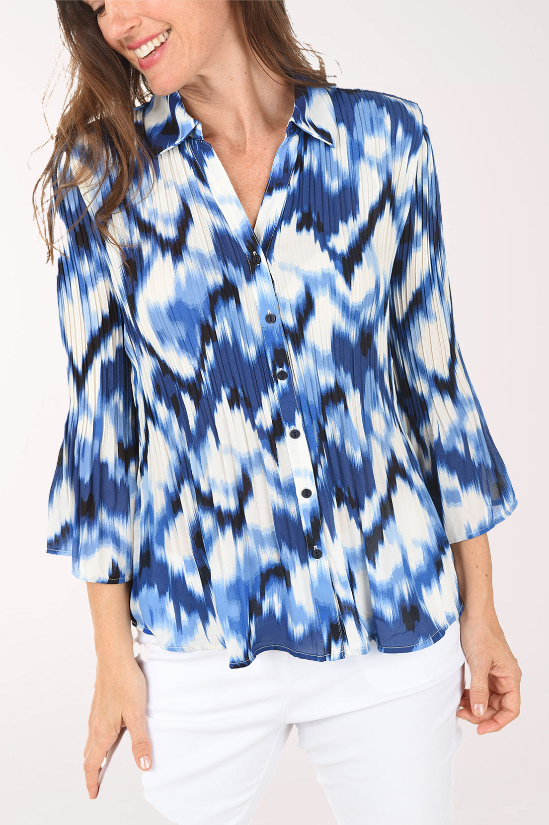 Woman wearing a blue and white tie-dye shirt on a white background